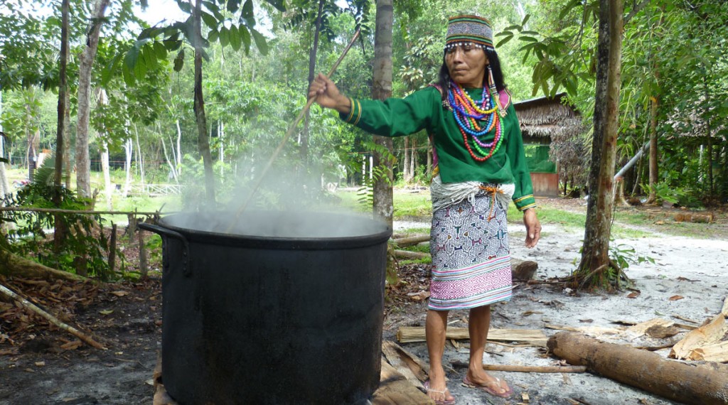 Traditional Shipibo Ayahuasca healer, Maestra Maria, attending the preparation of the Ayahuasca brew in Sacha Huarmi Ayahuasca retreat centre. Photo: M. Mori.