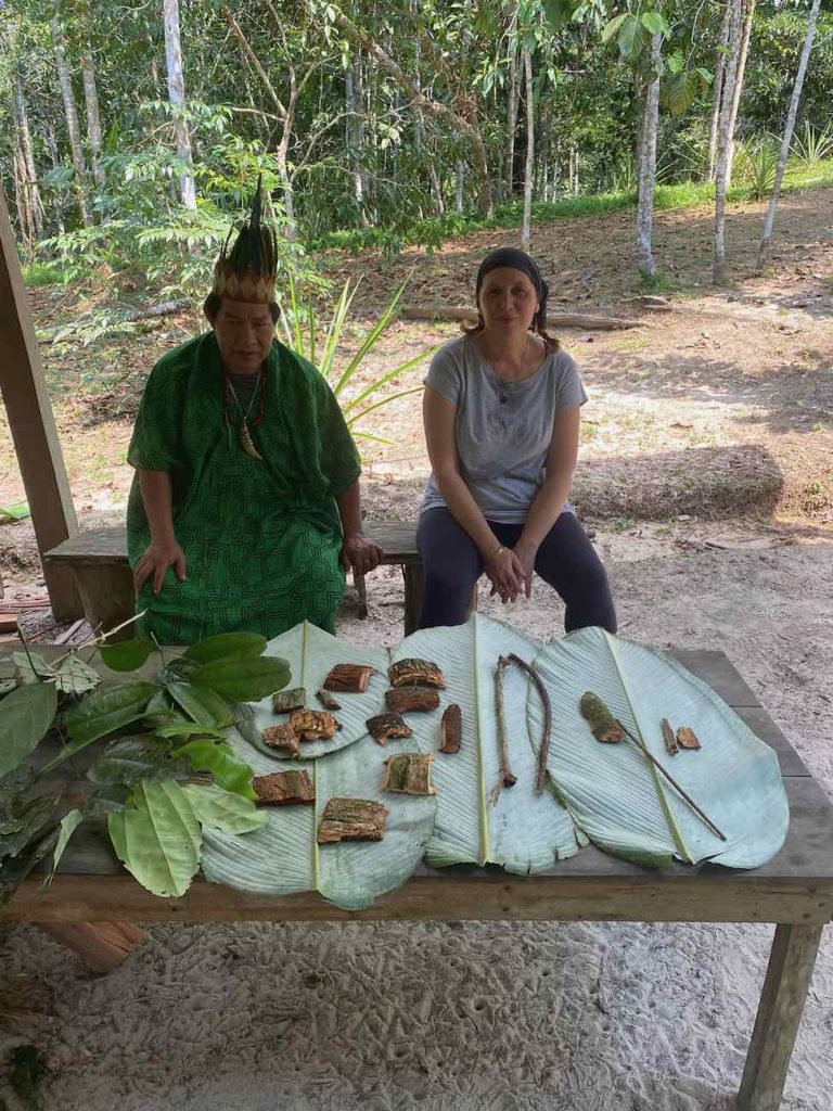 Don Armando and our Italian guest Laura with freshly harvested master trees parts, in the Peruvian Amazon jungle.
